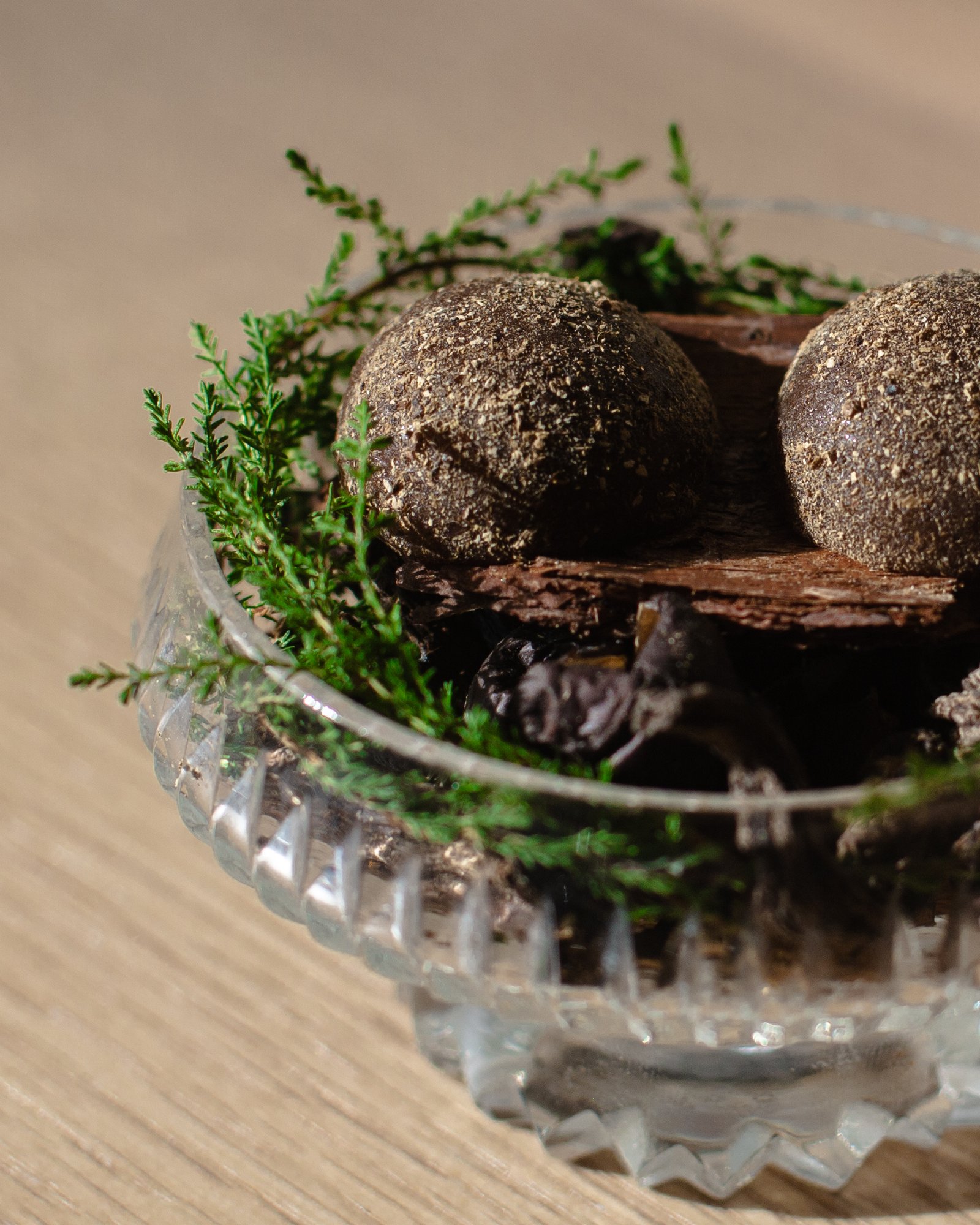 A sweet course served over bark and evergreen in a glass dish